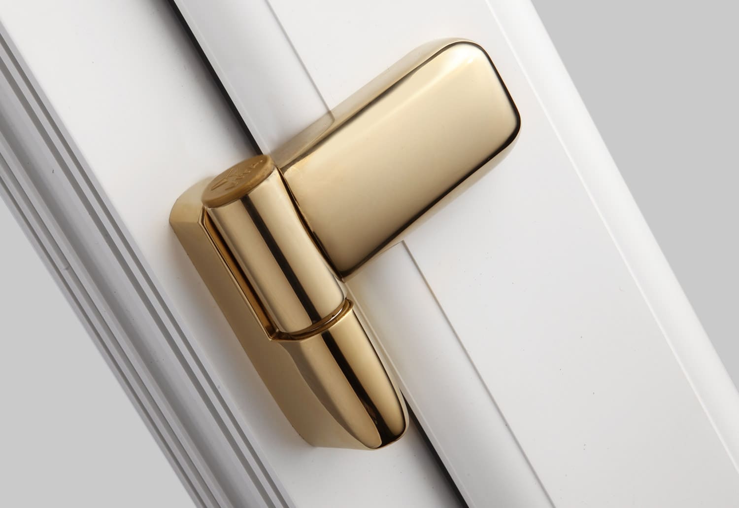 A gold door handle on a white door.