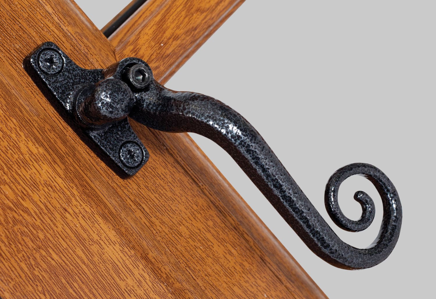 A door handle on a wooden door.