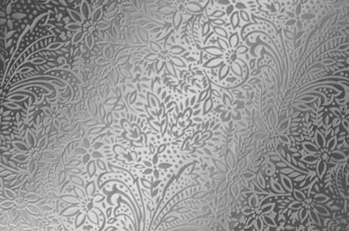 A silver wallpaper with a floral pattern.