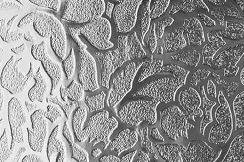 A close up image of a silver pattern on a wall.